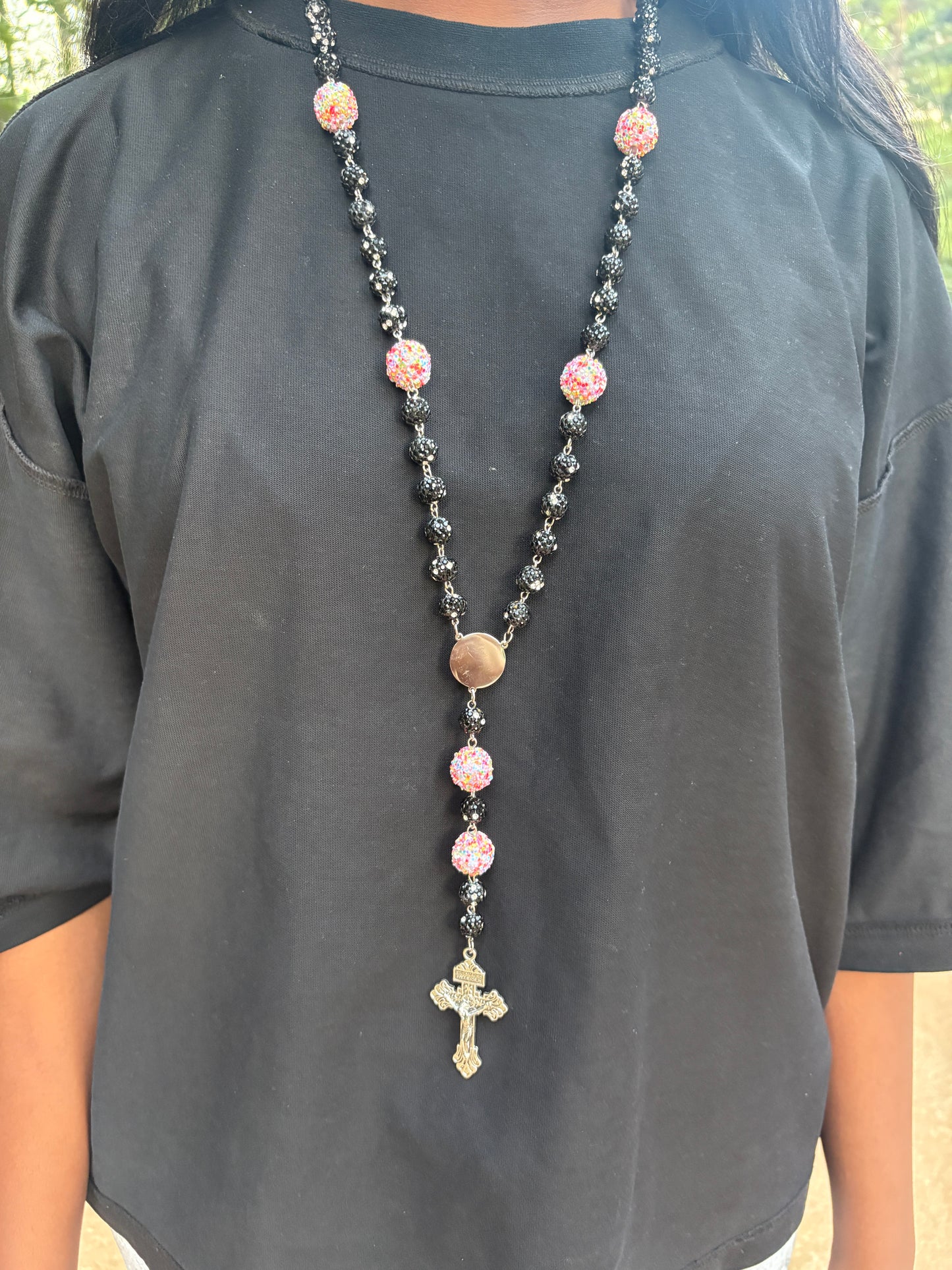 all black rosary with little pink rainbow